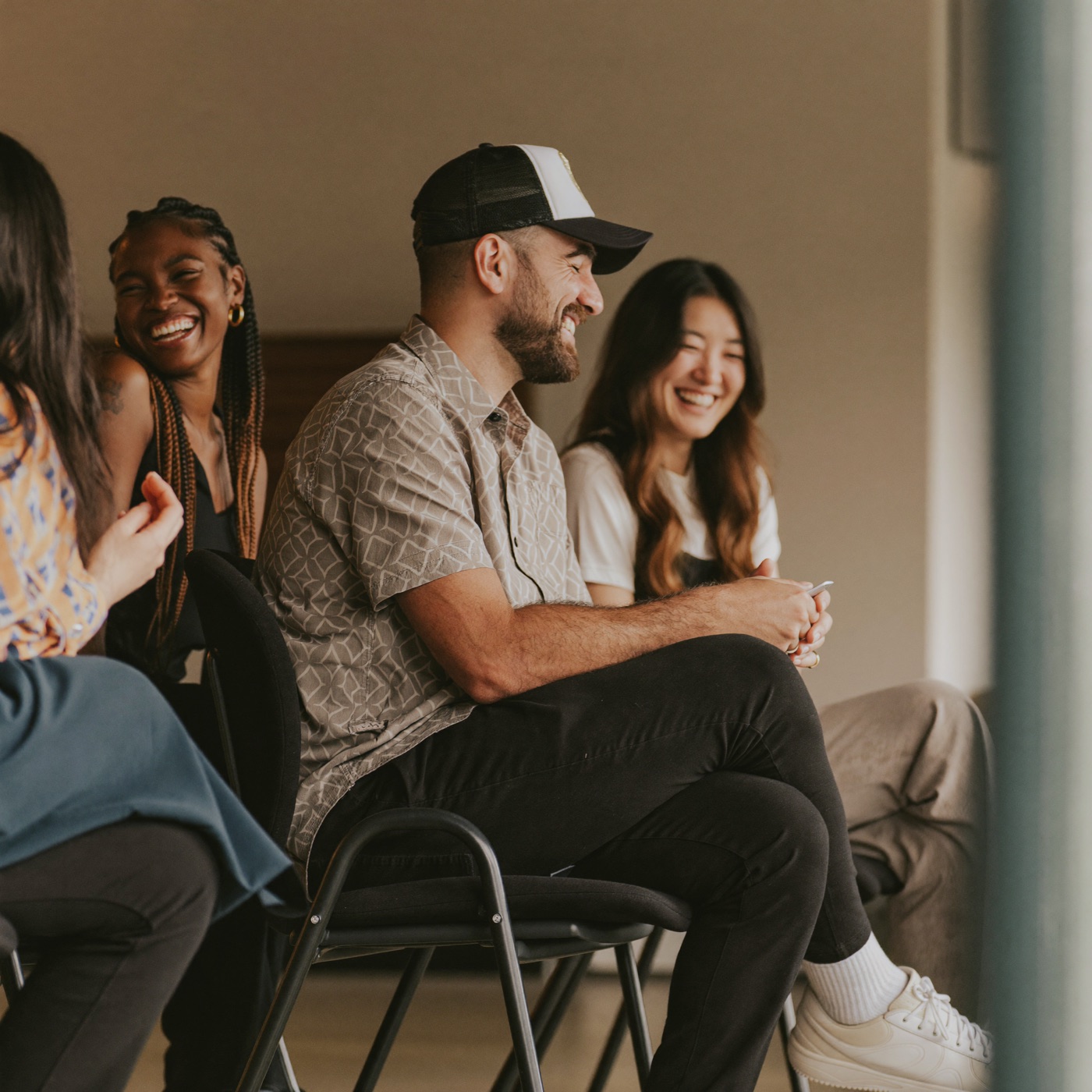 A diverse team of church volunteers laughing together during a planning meeting