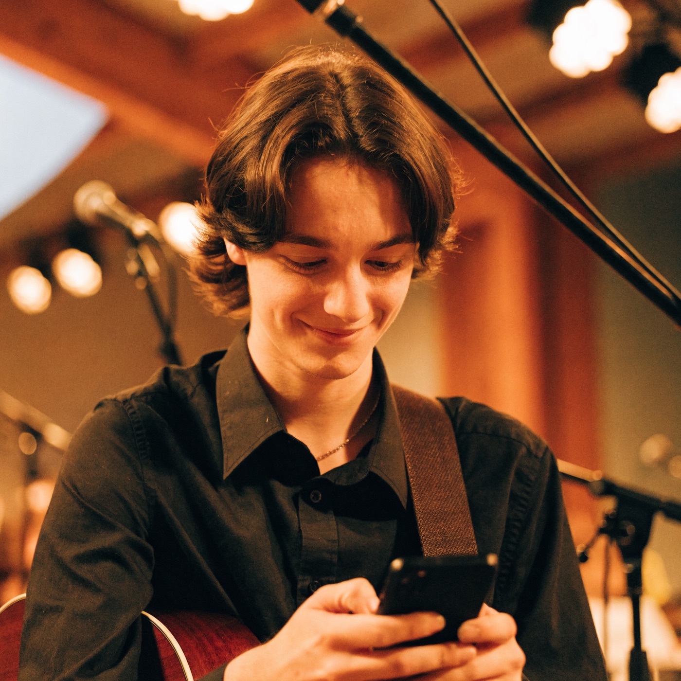 A worship musician checking their phone for a service reminder