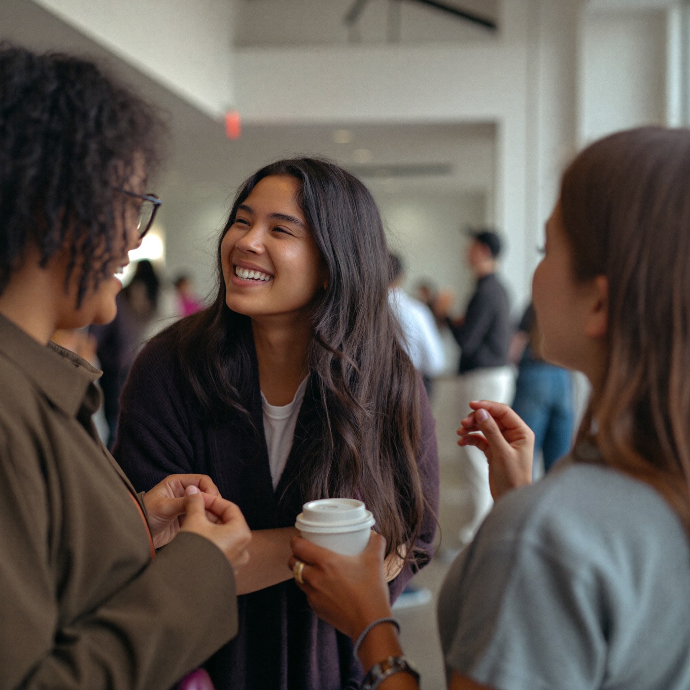 Church members laughing together in the lobby after a service